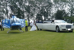 Bride steps from helicopter into wedding limousine